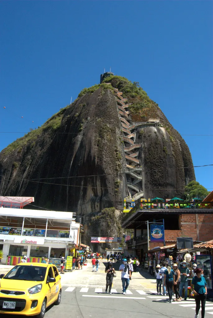 El Peñón de Guatapé and its zigzag staircase, seen from the town below